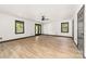 Living room featuring hardwood floors, a ceiling fan, windows, and doors to a balcony at 552 Blue Rock Dr, Charlotte, NC 28213