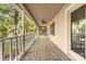 Long porch with white railing posts, string lights and a ceiling fan for cool nights at 552 Blue Rock Dr, Charlotte, NC 28213