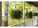 Inviting porch with hanging fern baskets, creating a serene and lush outdoor space at 552 Blue Rock Dr, Charlotte, NC 28213
