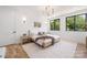 Bright bedroom featuring hardwood floors, two large windows offering an outdoor view, and neutral decor for a calm ambiance at 554 W Cama St, Charlotte, NC 28217