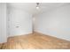 Clean bedroom featuring hardwood floors, a ceiling fan, and natural light from a large window at 554 W Cama St, Charlotte, NC 28217