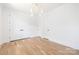 Bright bedroom with hardwood floors, neutral walls, and elegant lighting fixture at 554 W Cama St, Charlotte, NC 28217