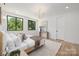 Serene bedroom with hardwood floors, large windows, and a minimalist aesthetic, bathed in natural light at 554 W Cama St, Charlotte, NC 28217