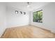 Bedroom featuring hardwood floors, a ceiling fan, and large windows that provide natural light at 554 W Cama St, Charlotte, NC 28217