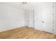 Minimalist bedroom with hardwood floors and multiple doors, providing a bright and open space at 554 W Cama St, Charlotte, NC 28217