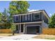Stylish two-story home showcasing a modern design, black trim windows, and a dark garage door at 554 W Cama St, Charlotte, NC 28217