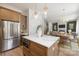 Open kitchen featuring stainless steel appliances, large island with pendant lighting, and hardwood floors at 554 W Cama St, Charlotte, NC 28217