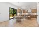 Bright and inviting kitchen and dining area with light wood cabinetry, stainless steel appliances, and a modern light fixture at 554 W Cama St, Charlotte, NC 28217