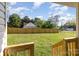 Spacious backyard with a wooden fence providing privacy and clear view from steps at 555 Pryor St, Chester, SC 29706