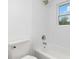 Clean white bathroom with a modern shower and tub and window offering natural light at 555 Pryor St, Chester, SC 29706