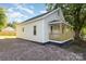 Side view of a light-colored home showcasing its clean lines and well-maintained gravel surrounding the property at 555 Pryor St, Chester, SC 29706