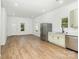 Open living space featuring modern flooring, stainless steel appliances, and a view of the front door at 555 Pryor St, Chester, SC 29706