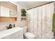 Charming bathroom with a floral shower curtain, decorative shelves, and a vanity at 604 Chaney Rd, Monroe, NC 28110