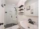 Modern bathroom with black and white accents, including a tiled shower and shelving at 604 Chaney Rd, Monroe, NC 28110
