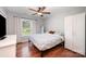 Cozy bedroom with hardwood floors, a bed with patterned bedding, and natural light at 604 Chaney Rd, Monroe, NC 28110