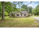 Charming single-story home with neutral siding, black shutters, a covered carport, and a well-manicured lawn at 604 Chaney Rd, Monroe, NC 28110