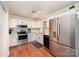Well-equipped kitchen with stainless steel appliances, white cabinetry, and sleek subway tile backsplash at 604 Chaney Rd, Monroe, NC 28110