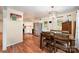 Eat-in kitchen featuring white cabinets, stainless steel appliances, and hardwood floors at 604 Chaney Rd, Monroe, NC 28110