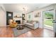 Inviting living room featuring a painted brick fireplace, hardwood floors, and a comfortable seating arrangement at 604 Chaney Rd, Monroe, NC 28110