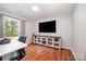 Well-lit office space with hardwood floors, a large window, and built-in storage at 604 Chaney Rd, Monroe, NC 28110