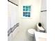 Bright bathroom with striped curtain, featuring one window and soft textures, and decorative accents at 611 Heathermoor Ct, Charlotte, NC 28209