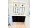 Elegant bathroom featuring dual sinks with modern gold fixtures, large mirrors, and stylish vanity at 611 Heathermoor Ct, Charlotte, NC 28209