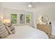 Serene bedroom with a ceiling fan, neutral tones, and ample natural light from multiple windows at 611 Heathermoor Ct, Charlotte, NC 28209