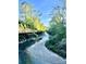 Scenic view of a tranquil creek surrounded by lush greenery and a walking bridge at 611 Heathermoor Ct, Charlotte, NC 28209