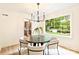 Charming dining area with natural light, contemporary chandelier, and views of the backyard at 611 Heathermoor Ct, Charlotte, NC 28209