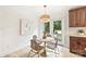 Charming dining area featuring a round table, wicker chairs, and French doors to the outside at 611 Heathermoor Ct, Charlotte, NC 28209