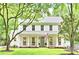 Charming two-story home with a well-manicured lawn, white siding, and a welcoming front porch at 611 Heathermoor Ct, Charlotte, NC 28209