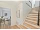 Bright foyer featuring wood stairs with white risers and access to the living area at 611 Heathermoor Ct, Charlotte, NC 28209