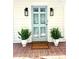 Inviting front entrance with a stylish door, brick walkway, and decorative potted plants at 611 Heathermoor Ct, Charlotte, NC 28209