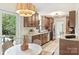 Beautiful kitchen features wood cabinets, stainless steel appliances, and a bright view of the backyard through large glass doors at 611 Heathermoor Ct, Charlotte, NC 28209