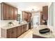 Well-appointed kitchen with wood cabinetry, granite countertops, stainless steel appliances, and sleek backsplash for modern appeal at 611 Heathermoor Ct, Charlotte, NC 28209