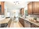The updated kitchen features wood cabinets, granite countertops, and stainless appliances, flowing seamlessly into the dining area at 611 Heathermoor Ct, Charlotte, NC 28209