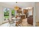 A modern kitchen is displayed with granite countertops, wood cabinets, stainless steel appliances, and a view of the outdoors at 611 Heathermoor Ct, Charlotte, NC 28209