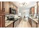 Spacious kitchen with wood cabinets, granite counters, and stainless steel appliances, perfect for culinary enthusiasts and entertaining at 611 Heathermoor Ct, Charlotte, NC 28209