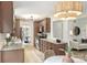 This open kitchen features wood cabinets, granite counters, and stainless appliances, seamlessly connecting to adjacent living areas at 611 Heathermoor Ct, Charlotte, NC 28209
