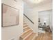 Elegant foyer with hardwood stairs, modern artwork, and a glimpse into the inviting living space at 611 Heathermoor Ct, Charlotte, NC 28209
