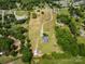 Picturesque aerial shot of a property with winding driveway and a home surrounded by verdant trees and open spaces at 6218 Indian Trail Fairview Rd, Indian Trail, NC 28079
