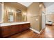 A bathroom featuring a dual sink vanity, mirrors, and an attached bedroom in view at 6218 Indian Trail Fairview Rd, Indian Trail, NC 28079