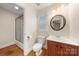 Well-lit bathroom showcases a wooden vanity, classic fixtures, and a shower-tub combination at 6218 Indian Trail Fairview Rd, Indian Trail, NC 28079