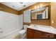 Bathroom featuring a shower-tub combo, a vanity with a sink, and a framed mirror at 6218 Indian Trail Fairview Rd, Indian Trail, NC 28079
