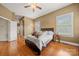 The main bedroom features hardwood floors, tan walls, and natural light at 6218 Indian Trail Fairview Rd, Indian Trail, NC 28079