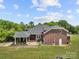Stunning brick home with a porte-cochere, a well-manicured lawn, and mature trees providing shade at 6218 Indian Trail Fairview Rd, Indian Trail, NC 28079
