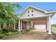 Charming single-Gathering home featuring a brick facade, covered entrance with columns, and an attached garage at 6218 Indian Trail Fairview Rd, Indian Trail, NC 28079