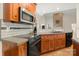 Kitchen featuring dark appliances, tile backsplash and a view into another room at 6218 Indian Trail Fairview Rd, Indian Trail, NC 28079