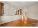 Open-concept living room boasts hardwood floors, seamlessly connecting to the kitchen and sunlit spaces at 6218 Indian Trail Fairview Rd, Indian Trail, NC 28079