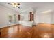 A beautiful living room featuring hardwood floors, columns, and large windows for ample sunlight at 6218 Indian Trail Fairview Rd, Indian Trail, NC 28079